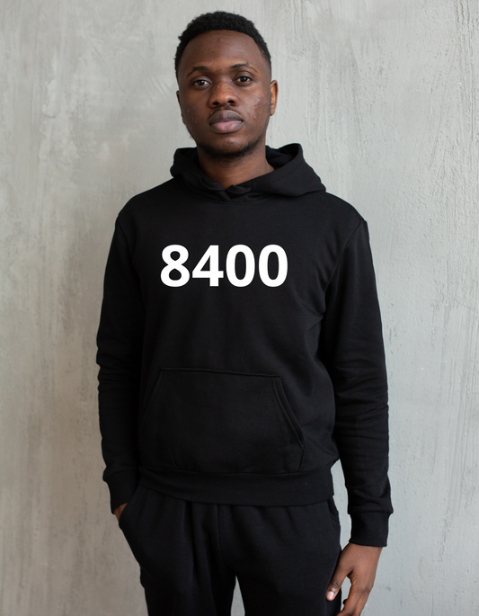 Zwarte hoodie met de witte opdruk ‘8400’, het postcode-nummer van Oostende, gedragen als casual streetwear.